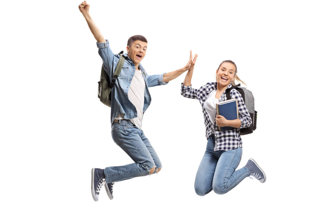 Pełna długość Portret dwóch uszczęśliwiony nastoletnich uczniów w powietrzu fiving siebie na białym tle - Zdjęcie, obraz