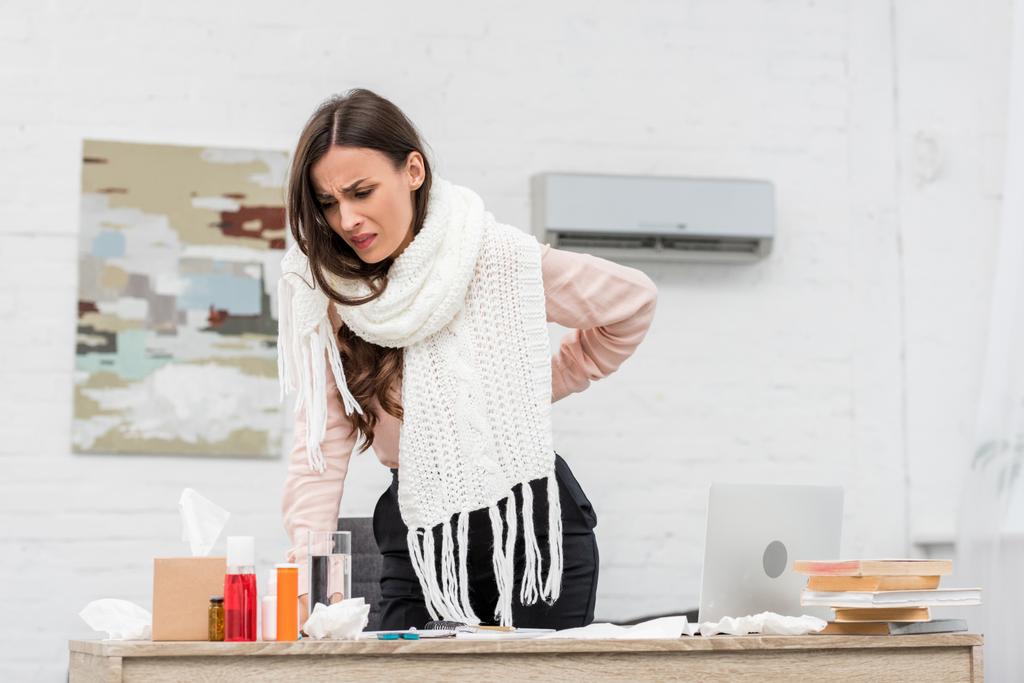 suffering sick businesswoman leaning on workplace with medicines - Photo, Image