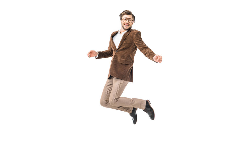 happy male model in eyeglasses and velvet jacket jumping isolated on white - Photo, Image