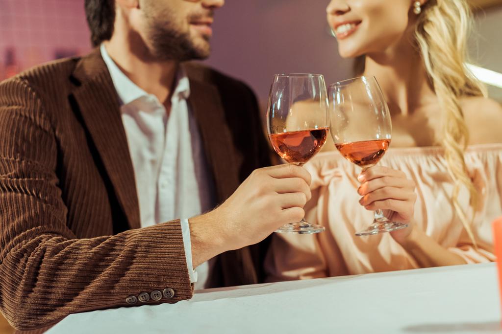частковий вид пари, що смердить келихами вина під час побачення за столом у кафе
 - Фото, зображення