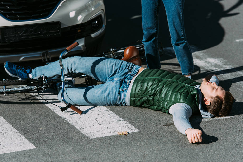 corte tiro de mulher de pé perto do ciclista ferido após acidente de carro
 - Foto, Imagem