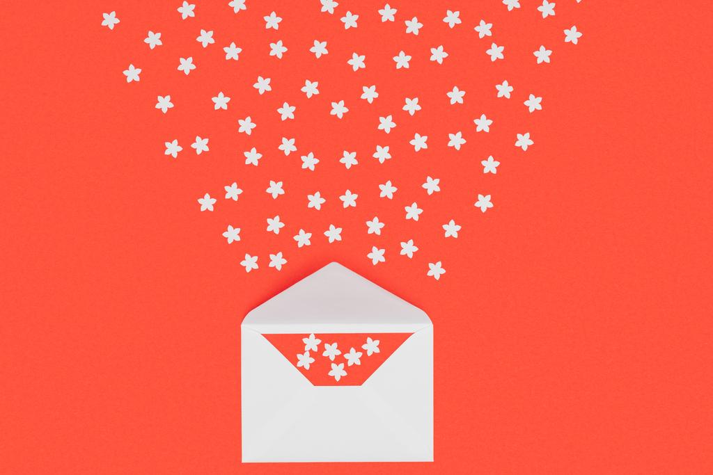 Крупный план белого конверта с красной карточкой и маленькими белыми звёздами, изолированными на красном
  - Фото, изображение
