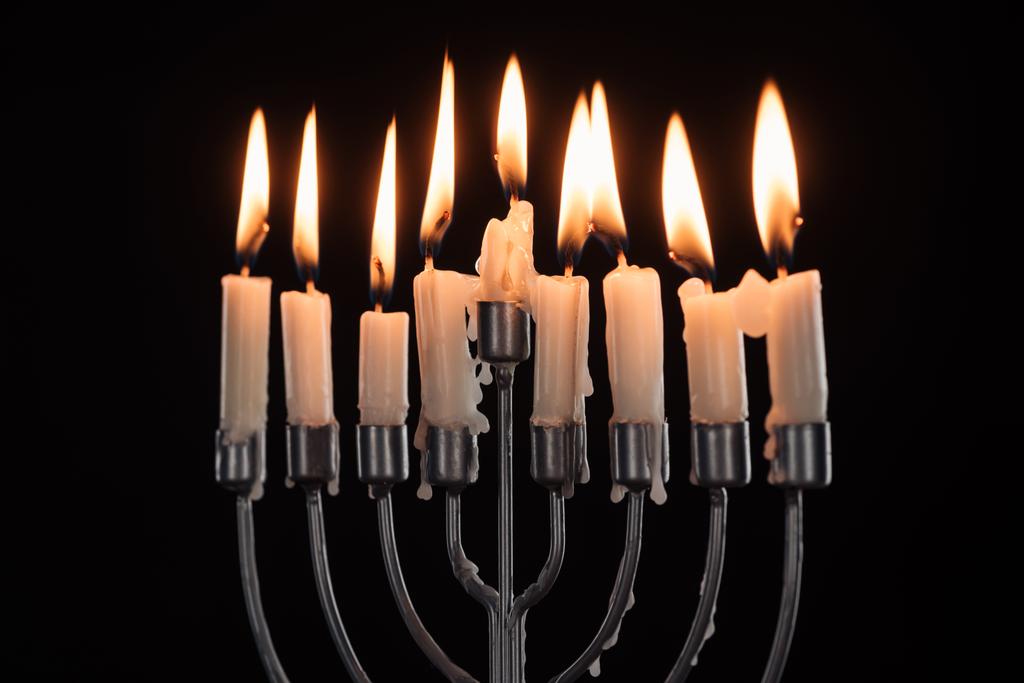 close up view of menorah with candles for hannukah holiday celebration isolated on black, hannukah concept - Photo, Image