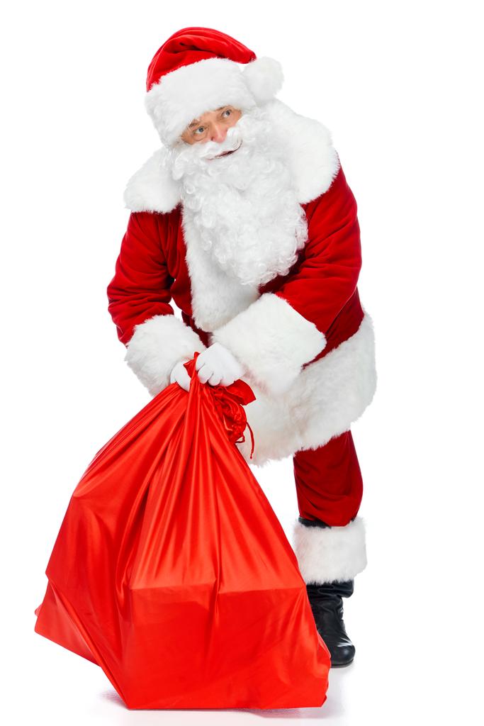 Kerstman die rode kerst tas geïsoleerd op wit - Foto, afbeelding