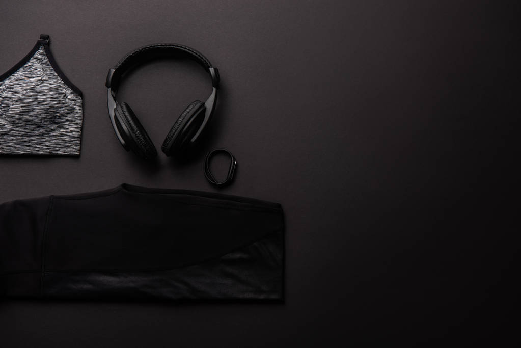 verhoogde weergave van gearrangeerde samenstelling met fitnessapparatuur geïsoleerd op zwart, minimalistische concept  - Foto, afbeelding