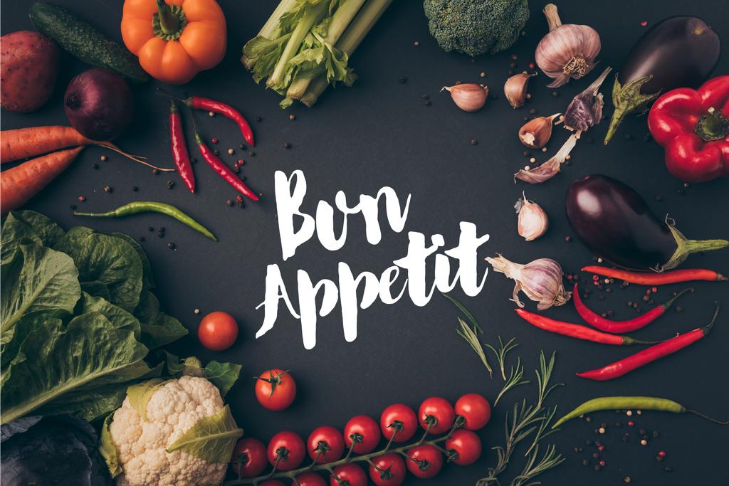 top view of unprocessed vegetables on gray table with bon appetit lettering - Photo, Image