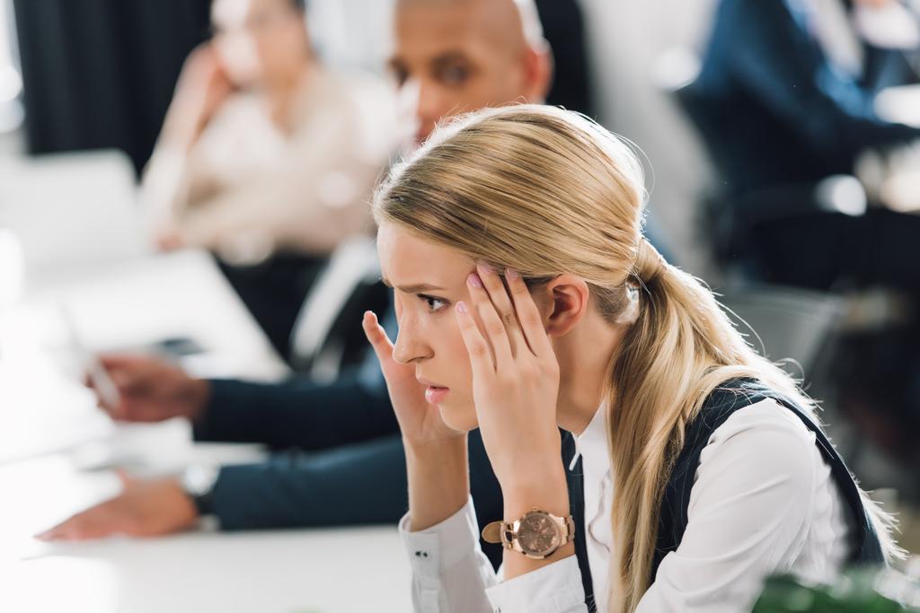 side view of stressed young businesswoman looking away in office - Photo, Image