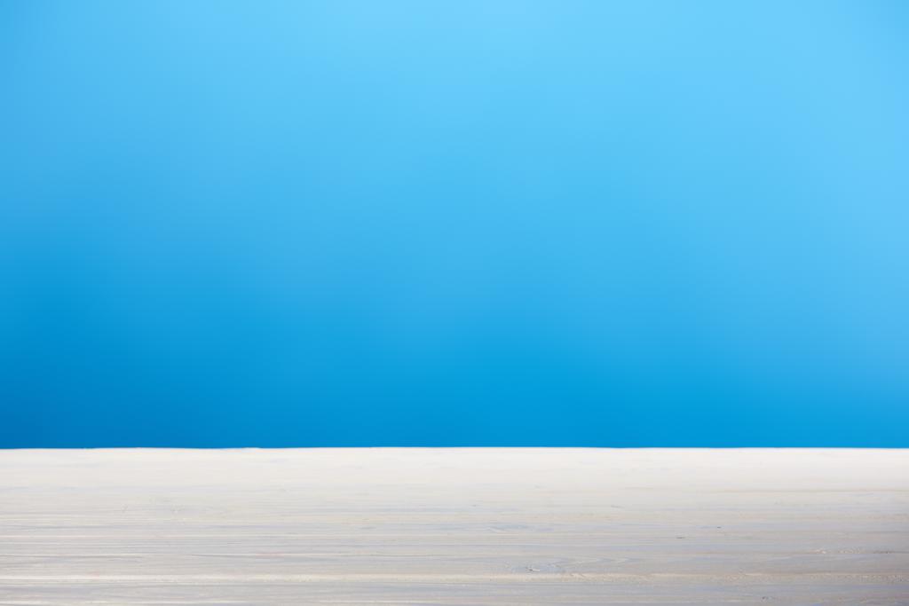 boş beyaz ahşap yüzey ve parlak mavi arka plan - Fotoğraf, Görsel