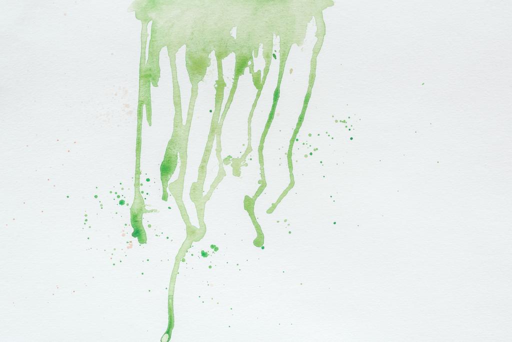 abstrakte grüne Aquarellflecken und Spritzer auf weißem Papier - Foto, Bild