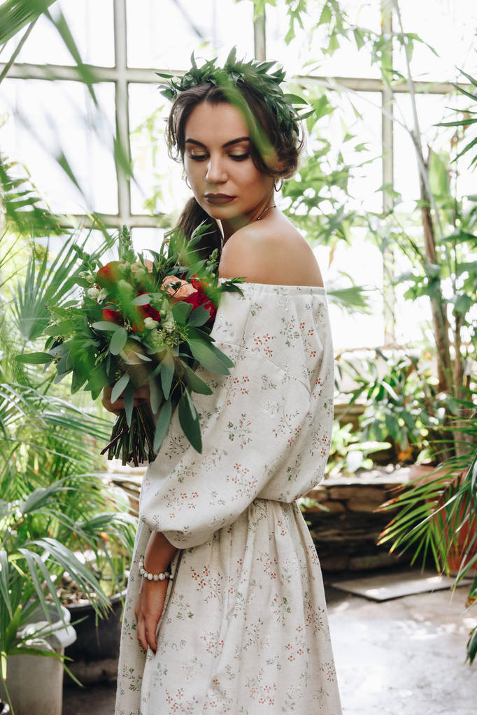 Beautiful bride with bouquet in botanical garden - Photo, Image