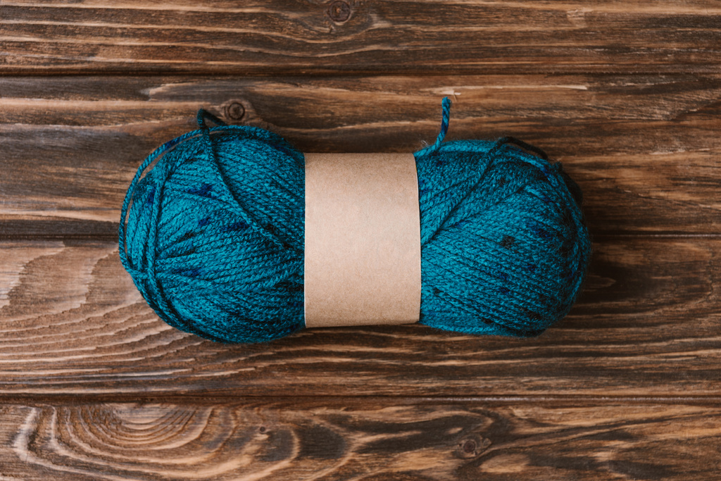 top view of blue yarn clew for knitting on wooden surface - Photo, Image