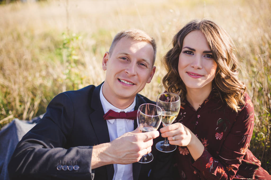 Beautiful young couple in love drinking wine outdoors  - Photo, Image
