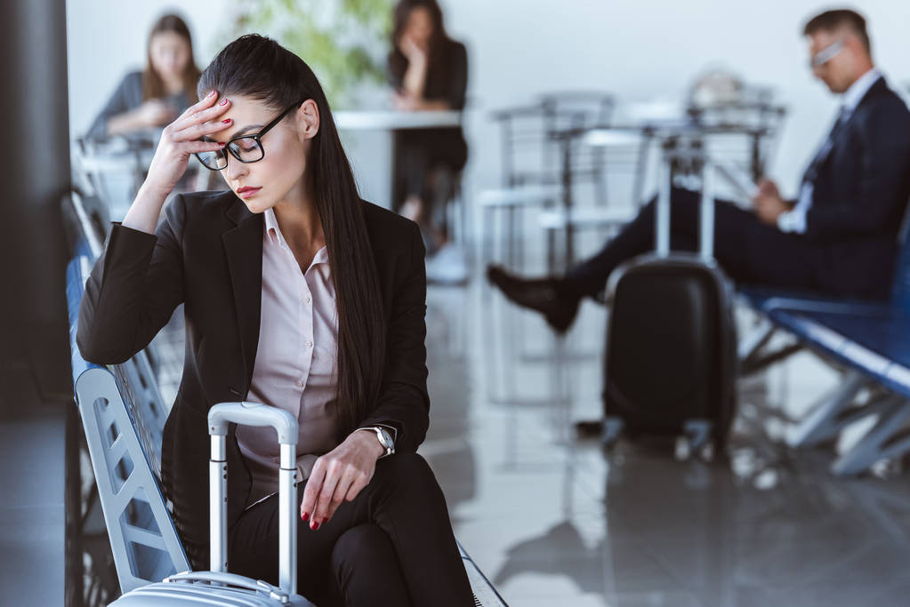 stanca donna d'affari seduta nella sala partenze dell'aeroporto
 - Foto, immagini