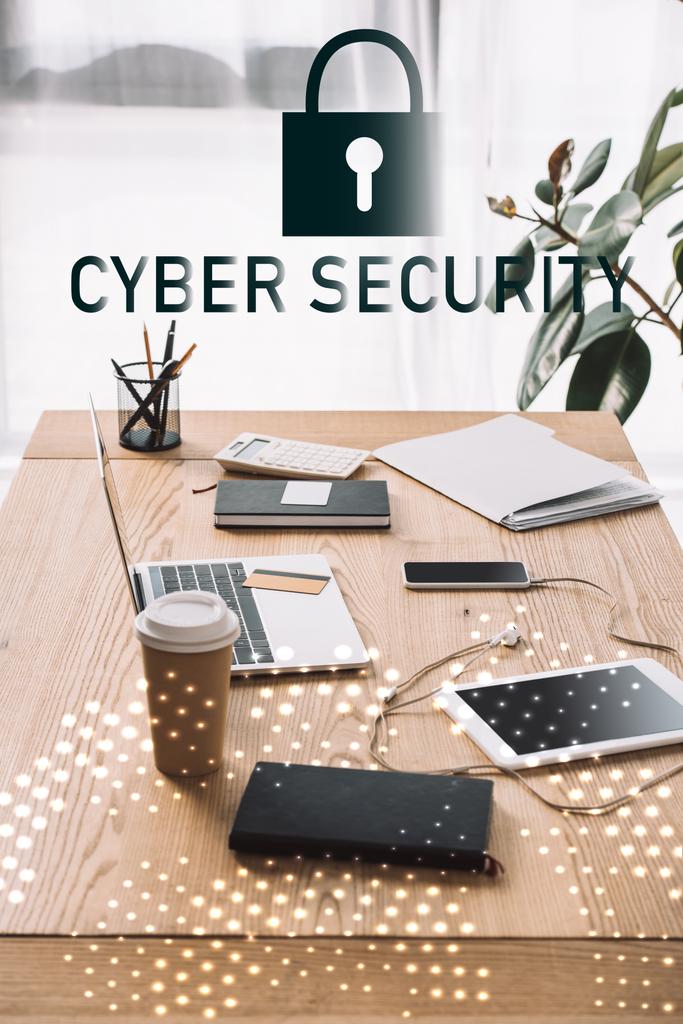 close up view of cyber security sign, workplace with laptop, coffee to go and notebook - Photo, Image