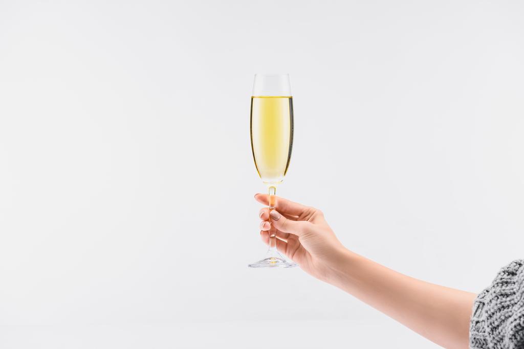 cropped shot of woman holding glass of champagne in hand isolated on white - Photo, Image