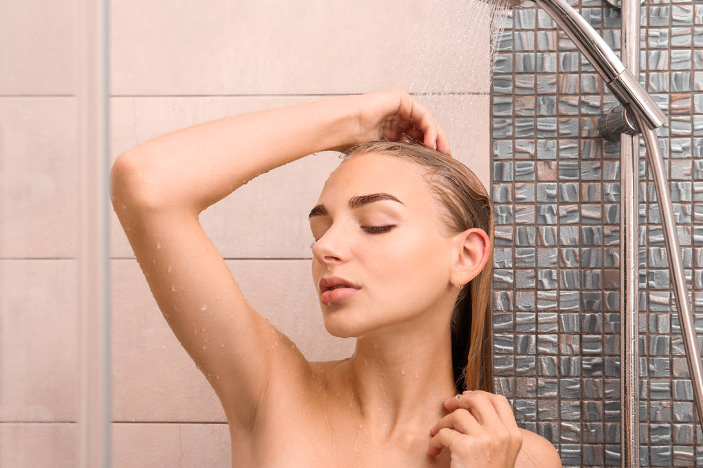 Hermosa mujer joven tomando ducha en casa - Foto, Imagen