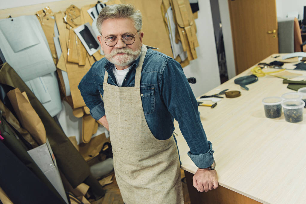 vue grand angle de heureux homme d'âge moyen artisan en tablier posant à l'atelier
 - Photo, image
