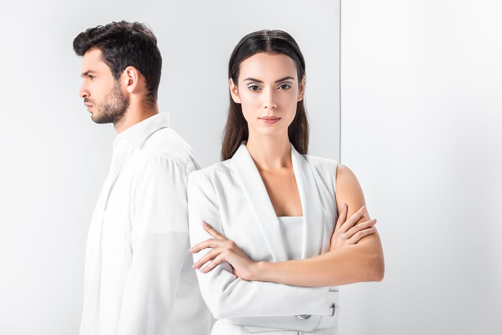adult stylish woman in total white standing with arms crossed near man  - Photo, Image