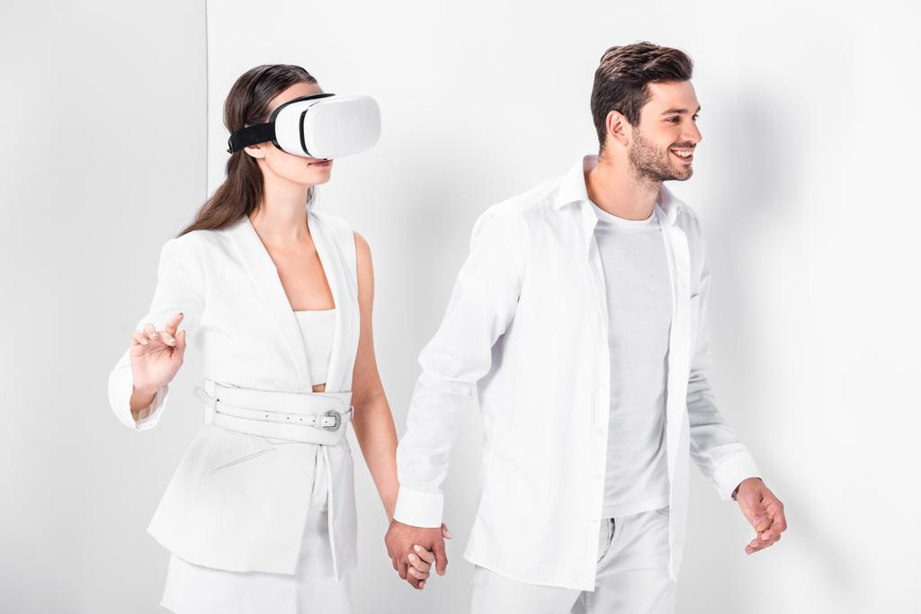 adult man walking with woman in virtual reality headset - Photo, Image