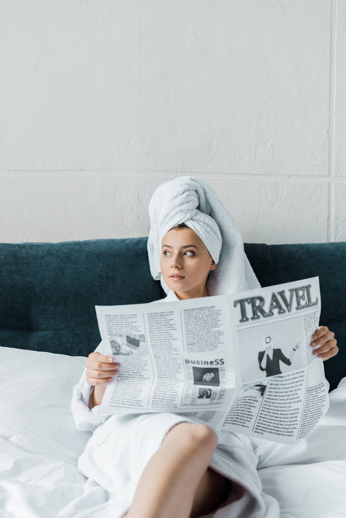 beautiful girl reading travel newspaper on bed - Photo, Image