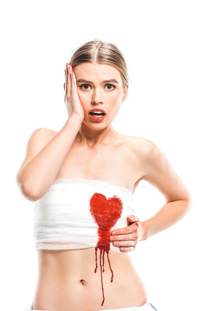 adult scared woman in bandages with bloody heart isolated on white - Photo, Image