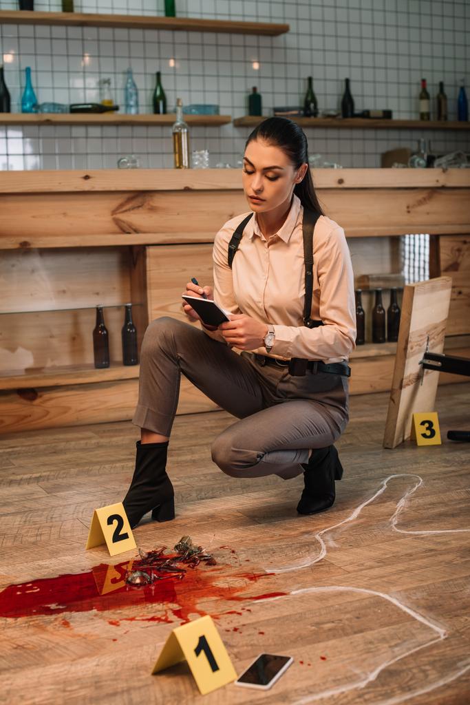female detective collecting data and investigating crime scene - Photo, Image
