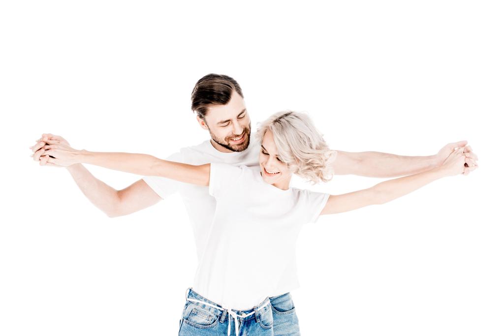 Maravillosa pareja sosteniendo frudamente las manos extendidas aisladas en blanco
 - Foto, imagen