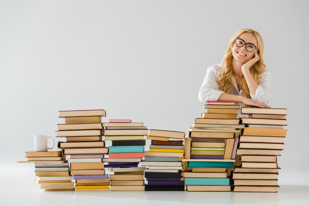 bela mulher em óculos sonhando perto de pilha de livros
 - Foto, Imagem