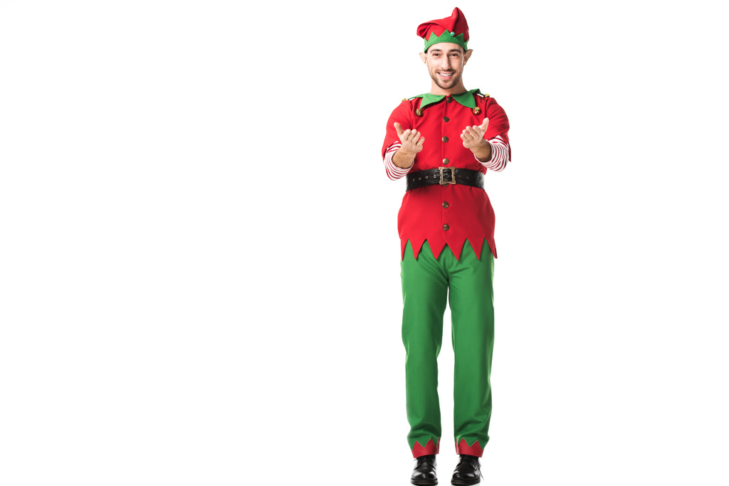 усміхнений чоловік у різдвяному ельфійському костюмі з простягнутими руками жест ізольований на білому
 - Фото, зображення