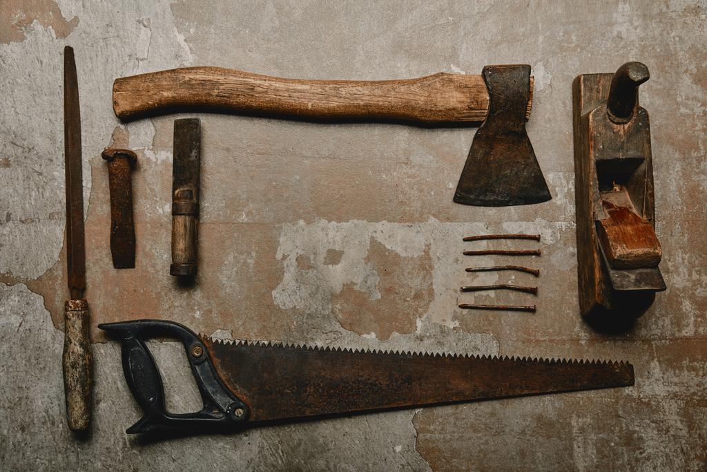 Flat lay with set of vintage rusty carpentry tools on old background - Photo, Image