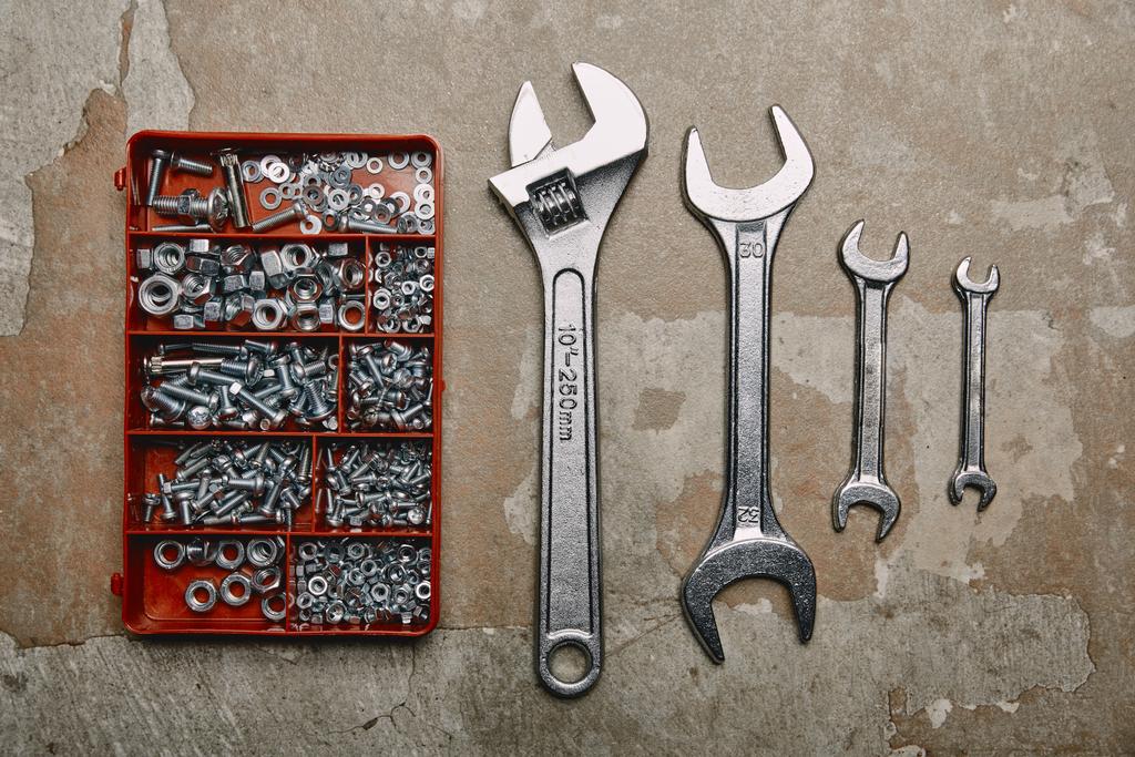 Flat lay with Set of wrenches tools and box of screws on the background of old  surface - Photo, Image