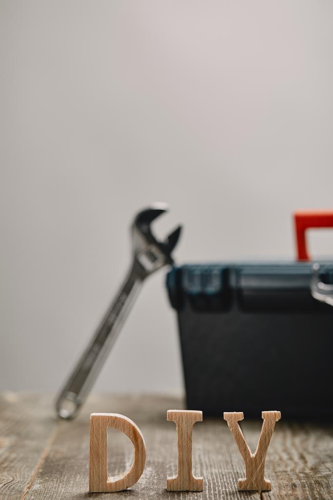 Распишитесь на деревянном столе на фоне ящика с инструментами и инструментами
  - Фото, изображение