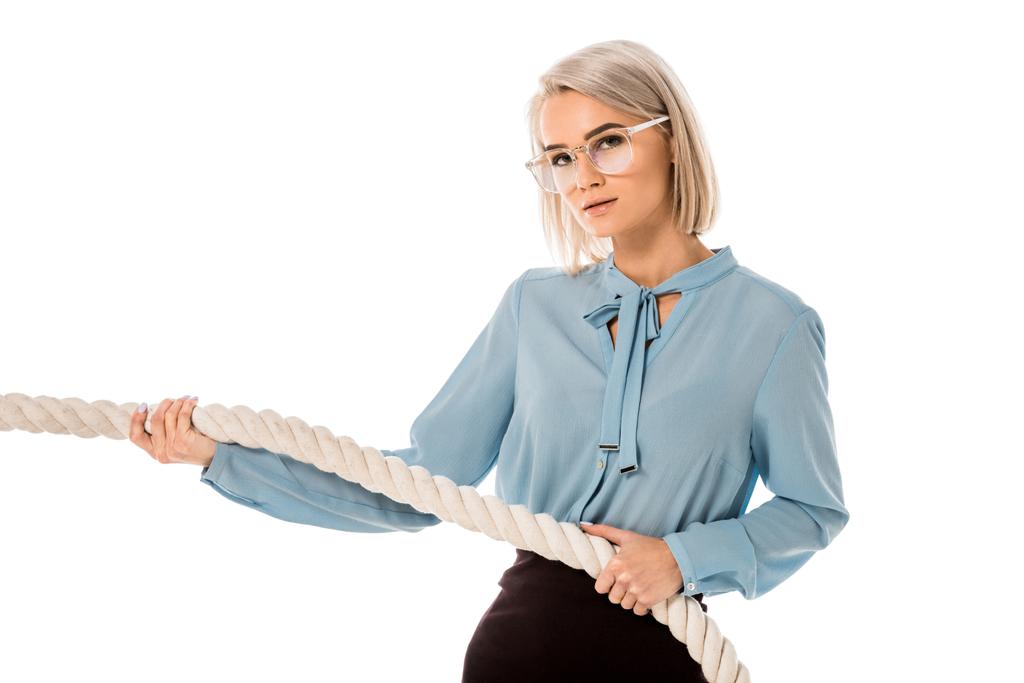 Beautiful blonde businesswoman in glasses pulling rope isolated on white - Photo, Image