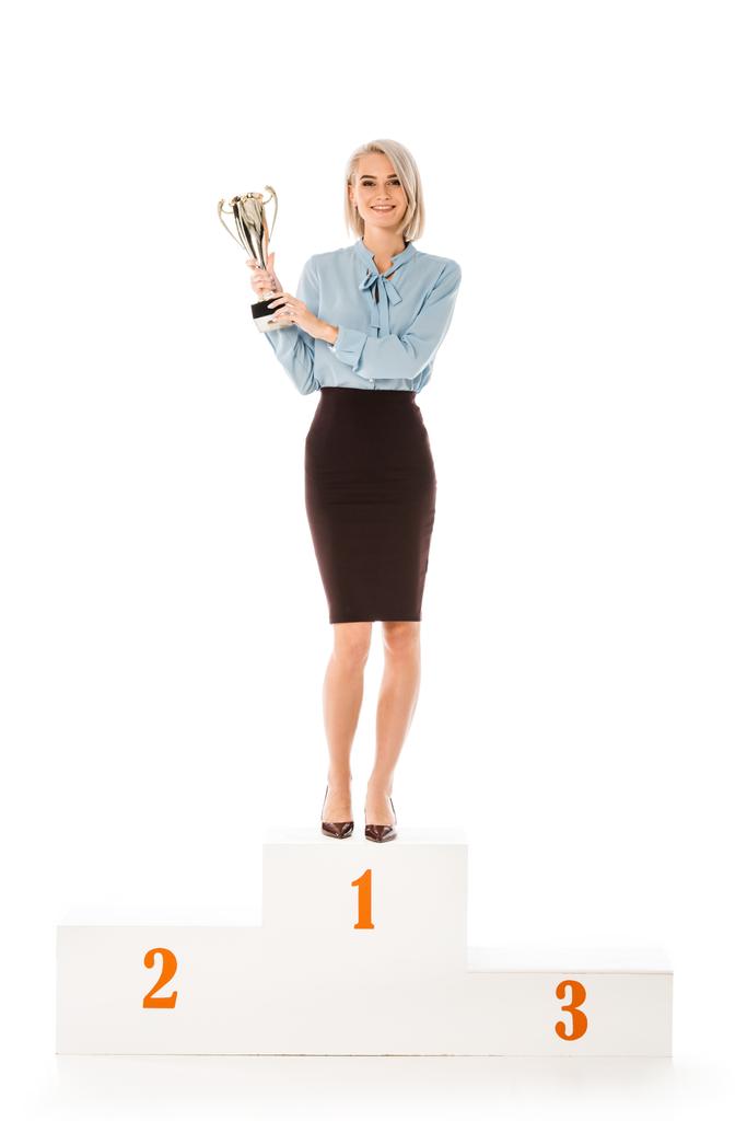 successful businesswoman with trophy cup standing on winners podium isolated on white - Photo, Image