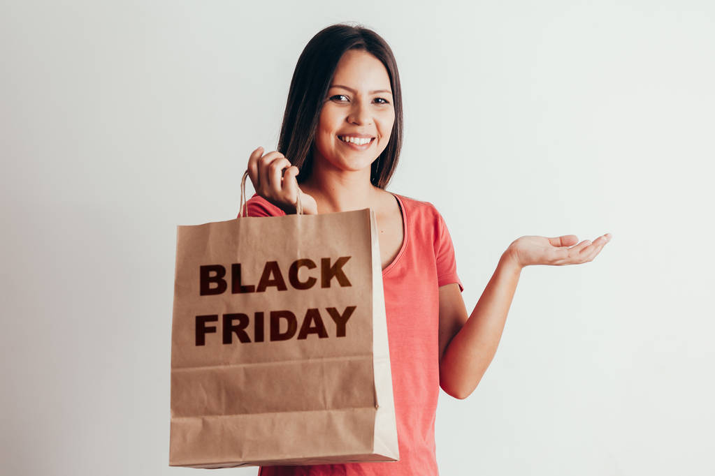 Portrait of casual woman with Black Friday paper bag - Photo, Image