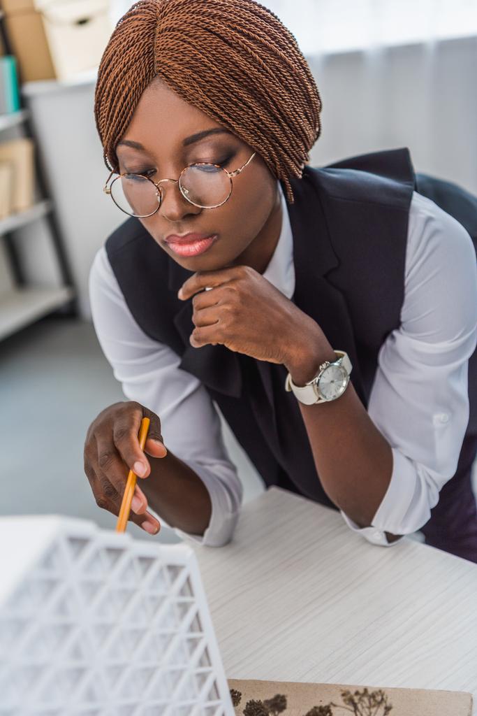 πορτρέτο του αφρικανικές αμερικανικές γυναίκες ενηλίκων αρχιτέκτονα γυαλιά κρατώντας στυλό και εργάζονται για την κατασκευή έργου στο office - Φωτογραφία, εικόνα