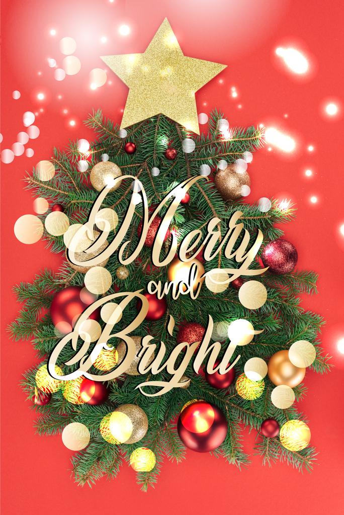 Ansicht von Tannenzweigen, goldenem Stern und Weihnachtskugeln in Weihnachtsbaum isoliert auf rot mit "fröhlich und hell" Schriftzug und Bokeh-Lichtern - Foto, Bild