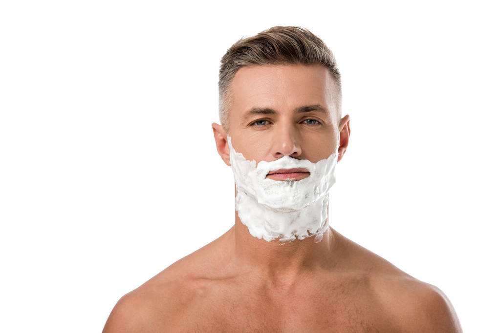 portrait of adult man with shaving foam on face looking at camera isolated on white - Photo, Image