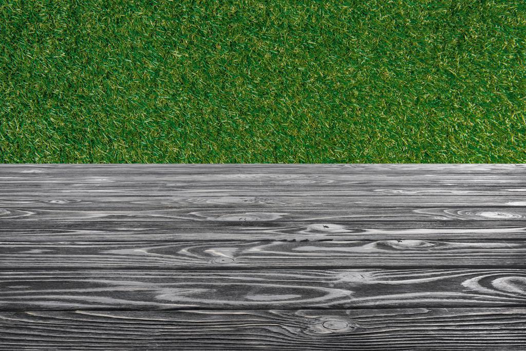 template of grey wooden floor with green grass on background - Photo, Image