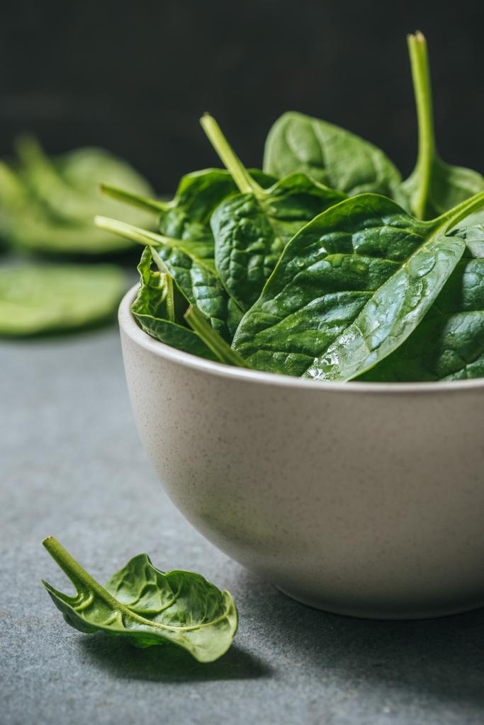 Fresh and wet spinach leaves in white bowl - Photo, Image