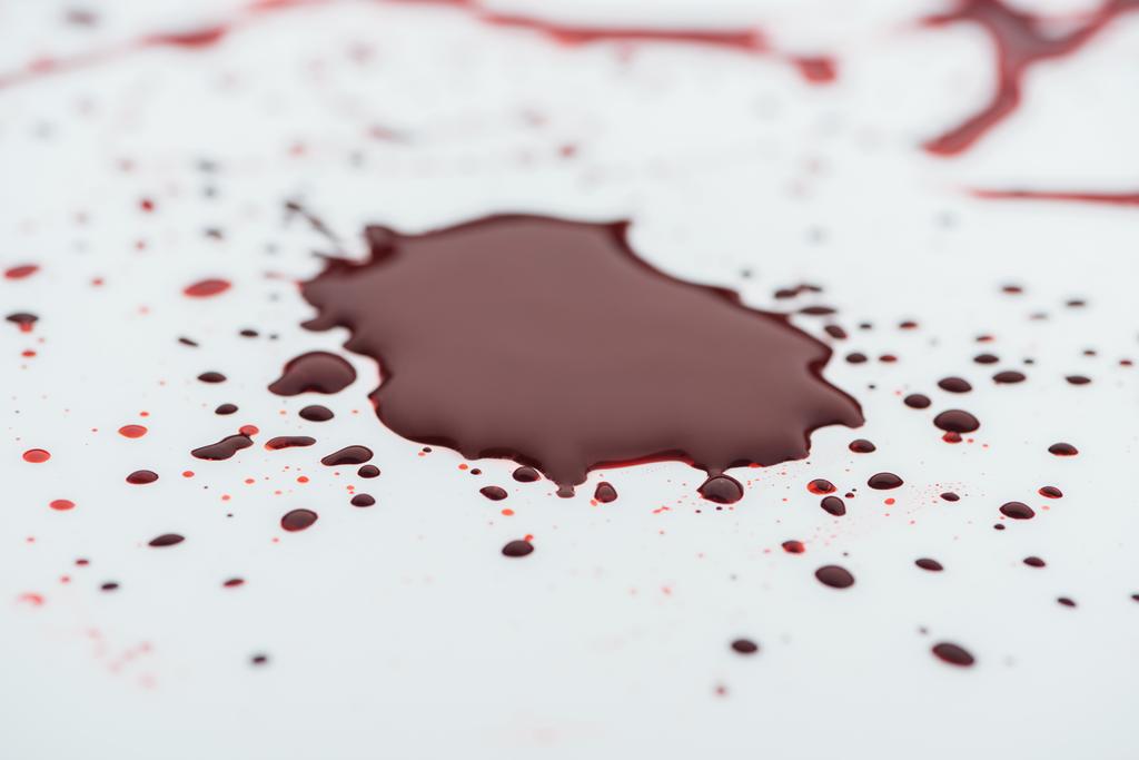 close-up shot of messy blood blot on white surface - Photo, Image
