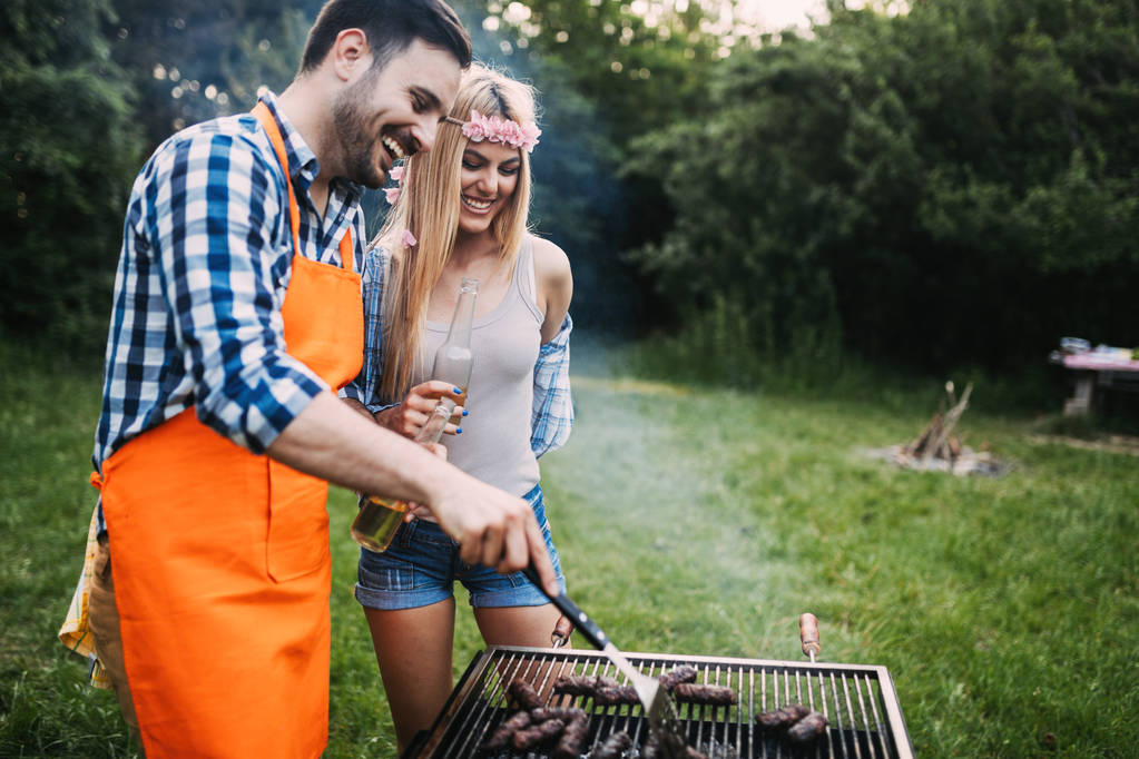 Beautiful woman and handsome man having barbecue - Photo, Image