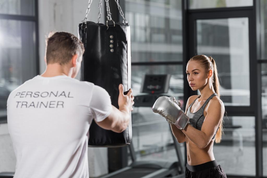 entrenador sosteniendo saco de boxeo, entrenamiento de boxeador atractivo en el gimnasio
 - Foto, Imagen