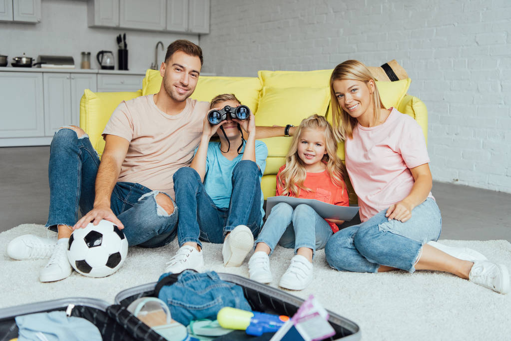 onnellinen perhe viettää hauskaa yhdessä pakatessaan kesälomalle, matka-konsepti
 - Valokuva, kuva