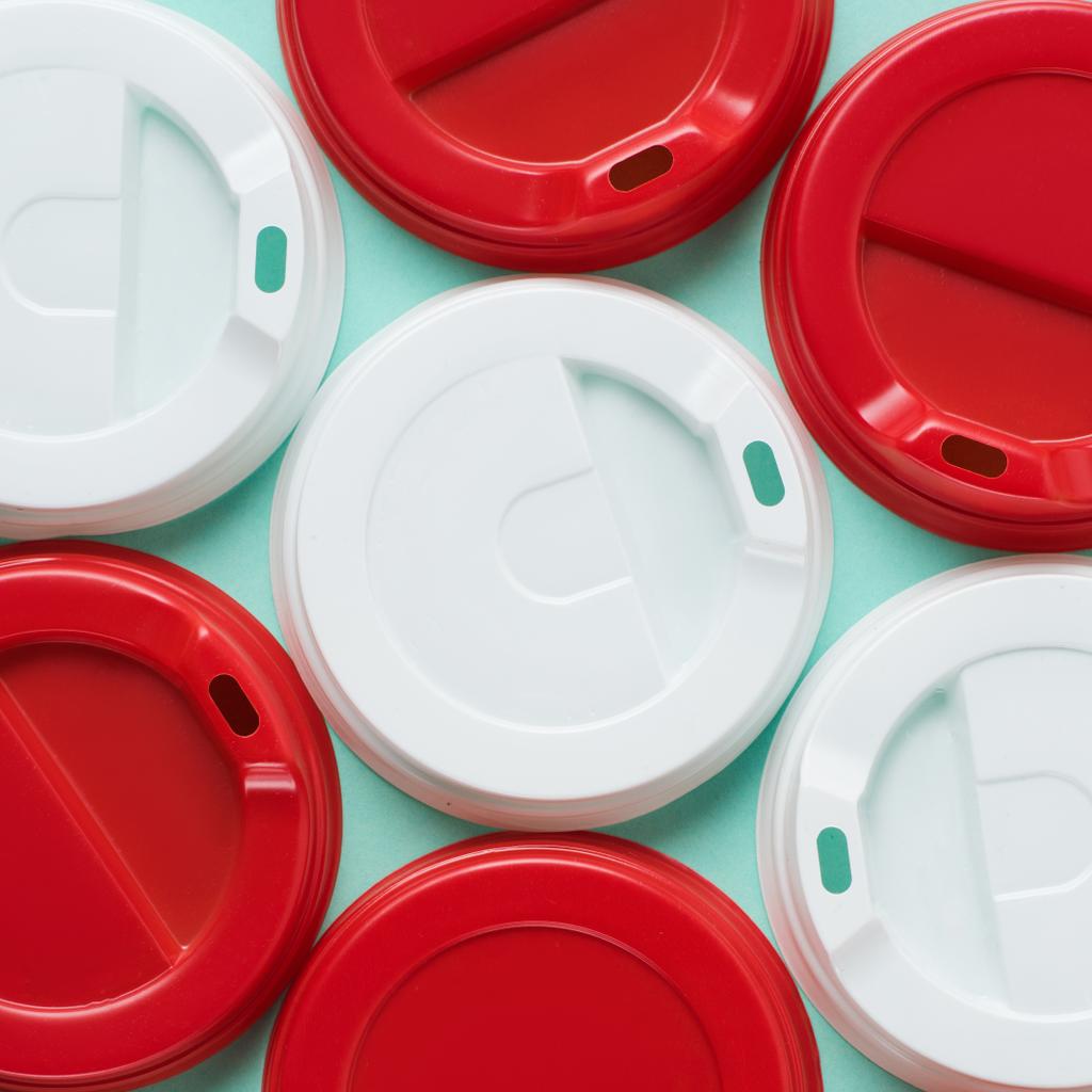 Close up view of red and white lids for drink on blue backgroun - Photo, Image