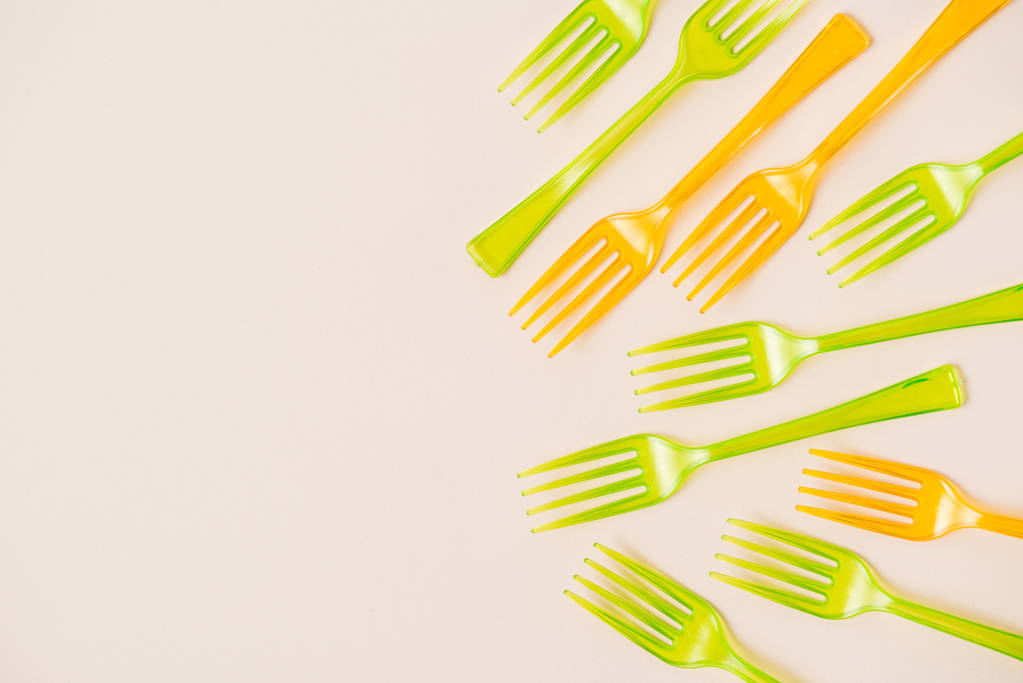 Top view of colorful plastic forks on pink background - Photo, Image