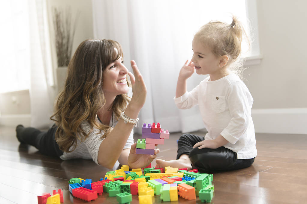 Mother and child daughter building from toy blocks at home - Photo, Image