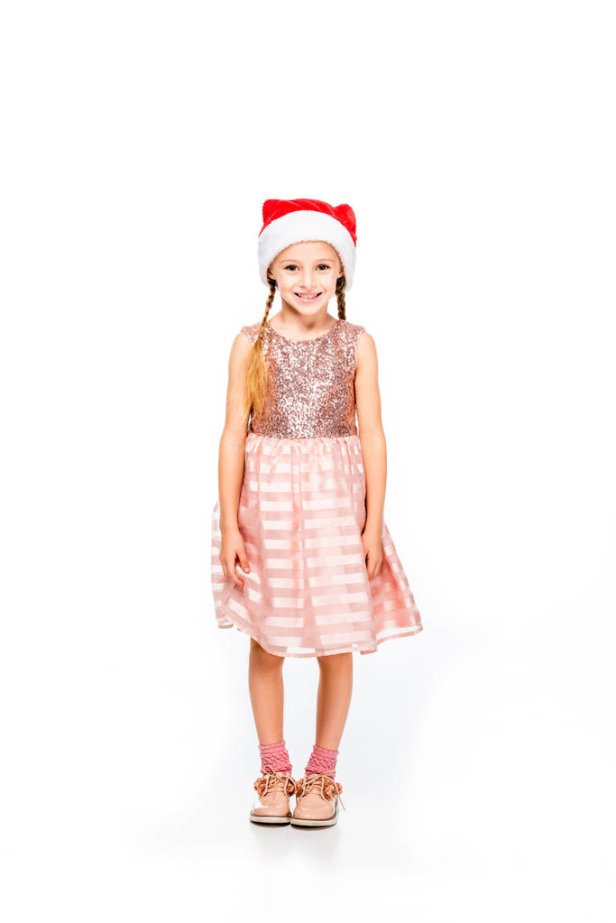 adorable little child in santa hat and dress looking at camera isolated on white - Photo, Image