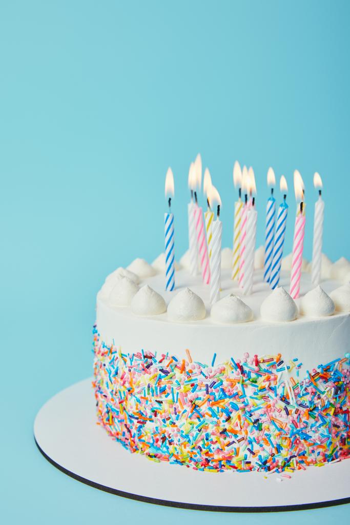Birthday cake with lighting candles on blue background - Photo, Image