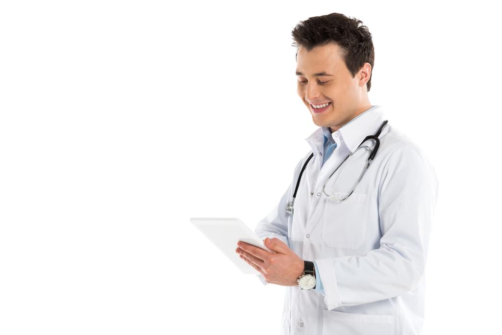 handsome male doctor with stethoscope using digital tablet isolated on white - Photo, Image